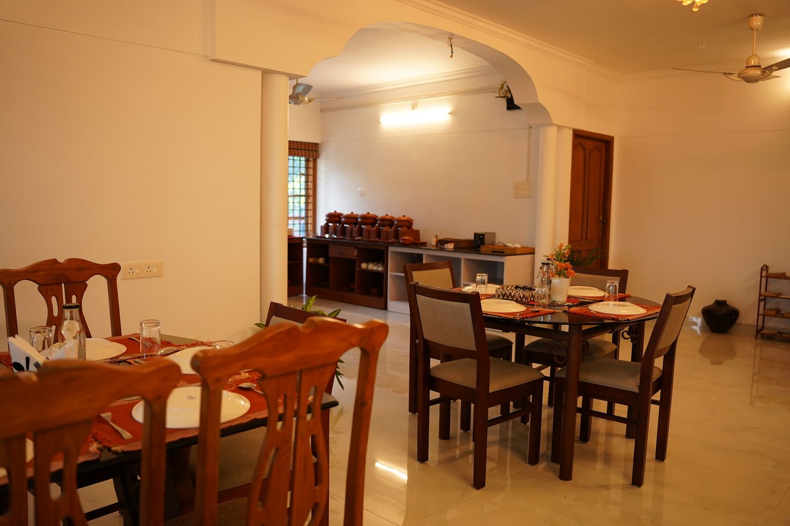The dining room at Casa with wooden tables laid for breakfast