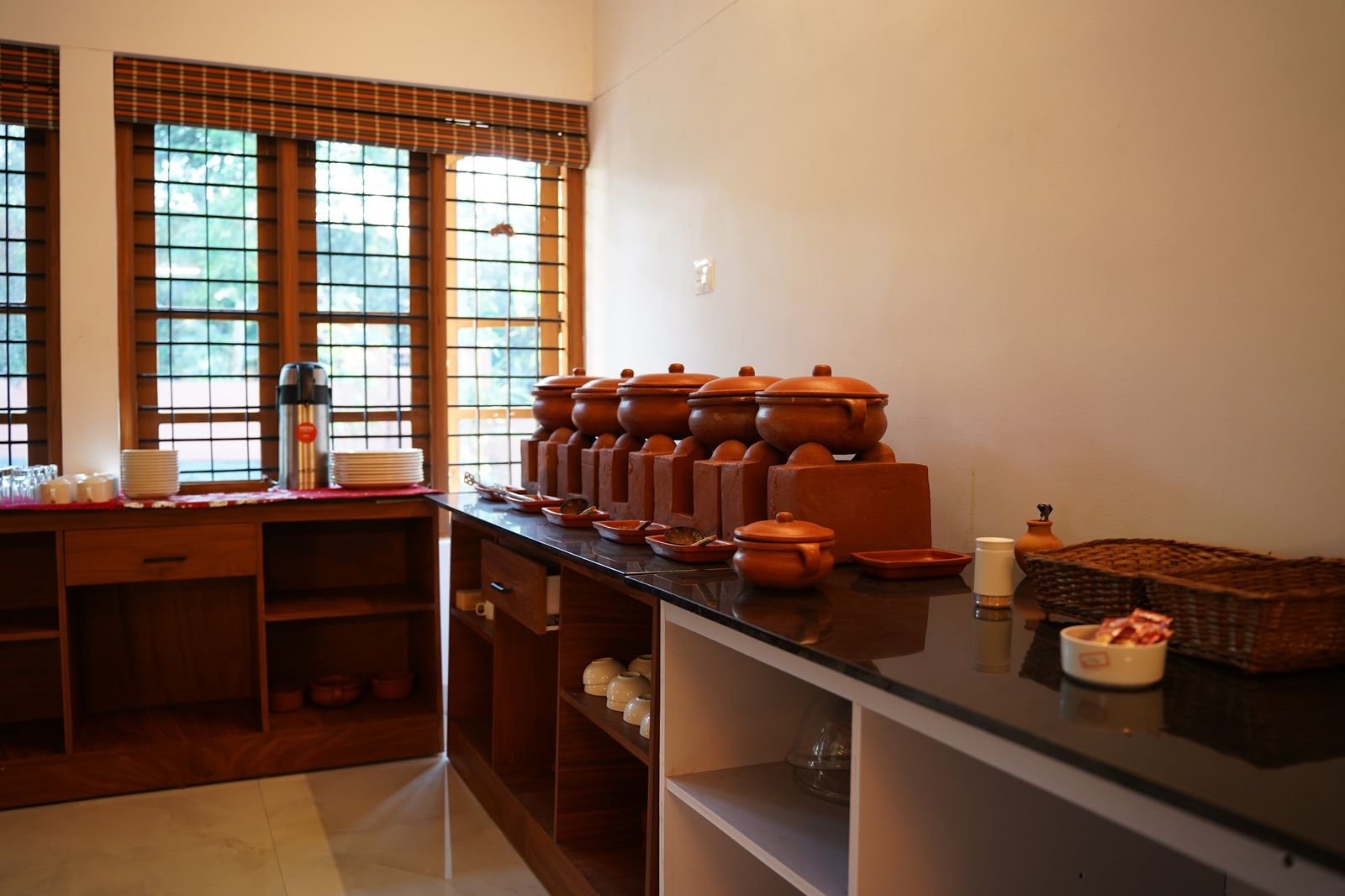 Clay pots lined up on the counter of the open kitchen at Casa