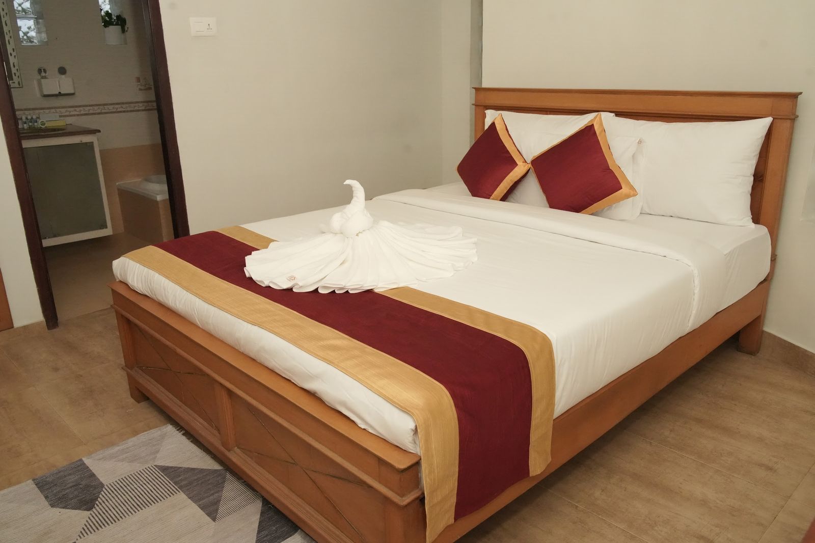 The Nest at The Cove, a double bed with a folded towel swan